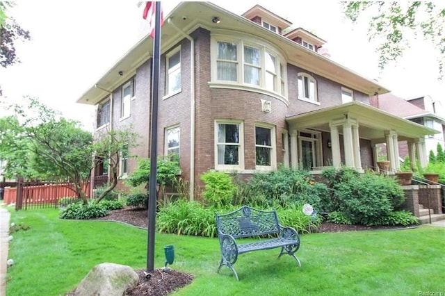 rear view of property featuring a yard