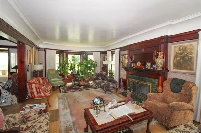 living room featuring hardwood / wood-style flooring, ornamental molding, and a brick fireplace