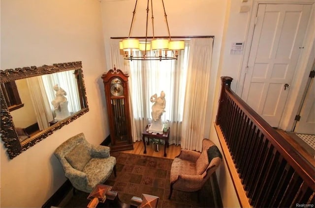 sitting room with a chandelier and hardwood / wood-style flooring