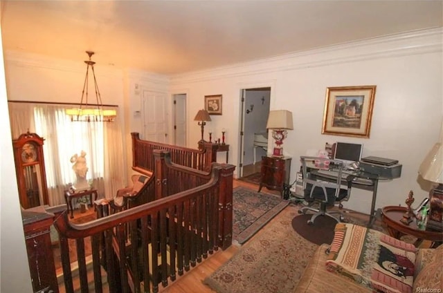 interior space with ornamental molding, hardwood / wood-style flooring, and a notable chandelier