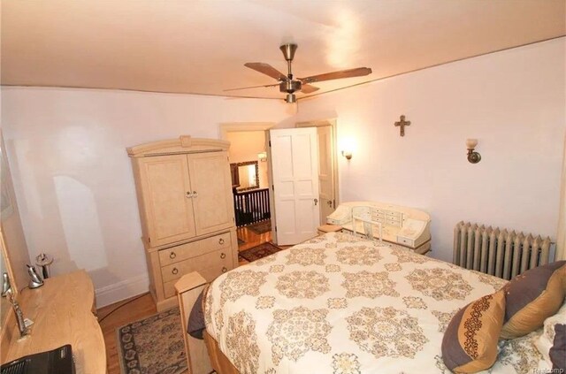 90 Edison St, Detroit, MI 48202 - bedroom with radiator heating unit, ceiling fan, and baseboards