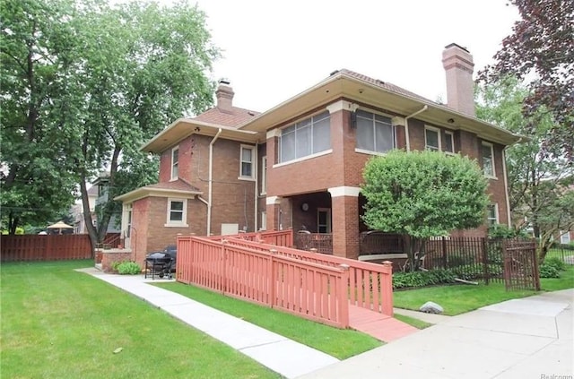 back of house with a lawn