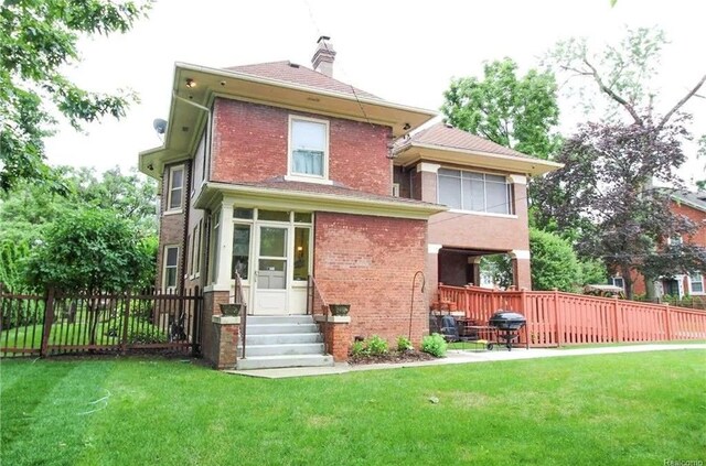 90 Edison St, Detroit, MI 48202 - back of property with entry steps, brick siding, and a chimney