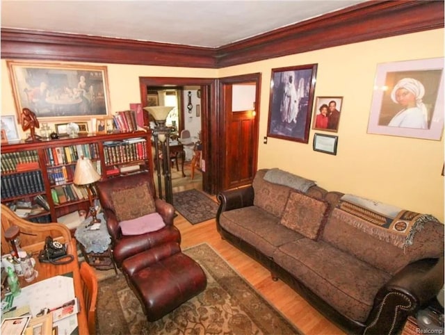 living room with wood-type flooring and ornamental molding