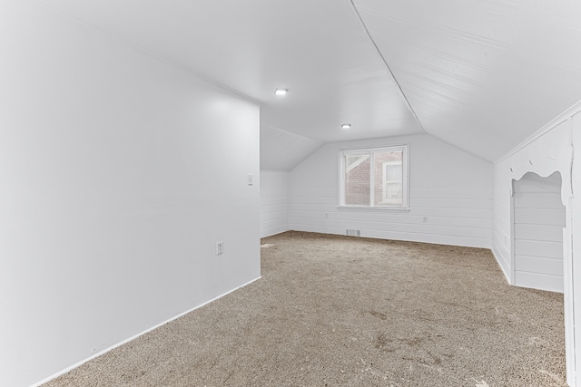 bonus room with carpet floors and vaulted ceiling