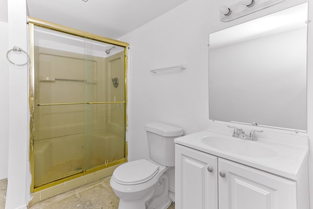 bathroom with a shower with door, vanity, and toilet