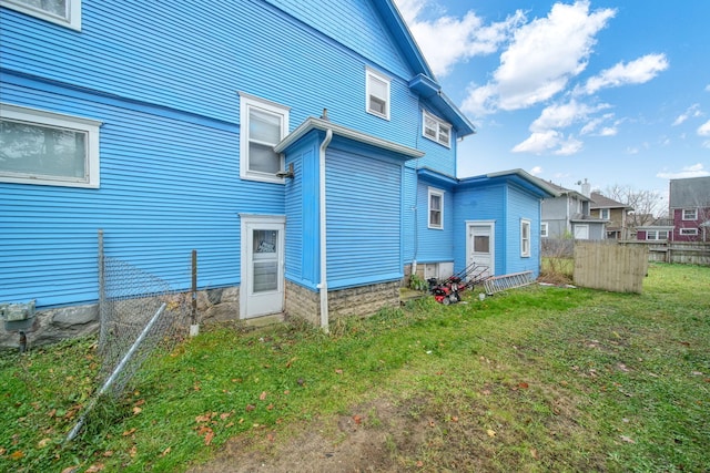 rear view of property featuring a yard