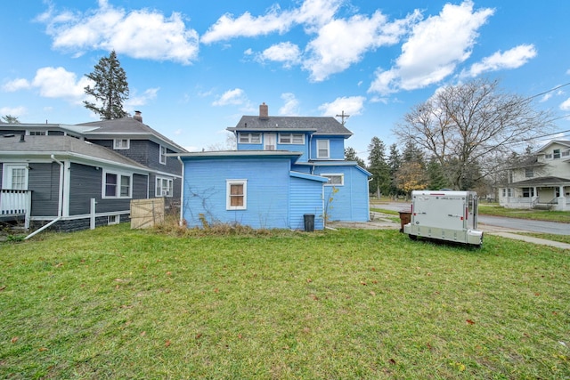 back of house featuring a yard