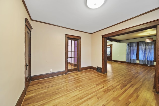 spare room with hardwood / wood-style floors and ornamental molding