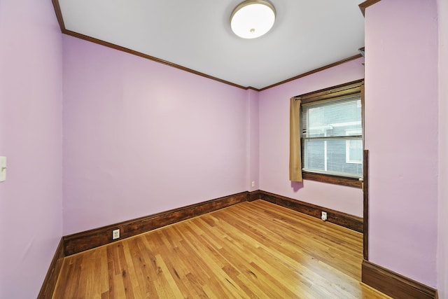 spare room with ornamental molding and hardwood / wood-style flooring