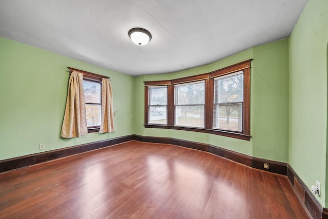 unfurnished room with wood-type flooring