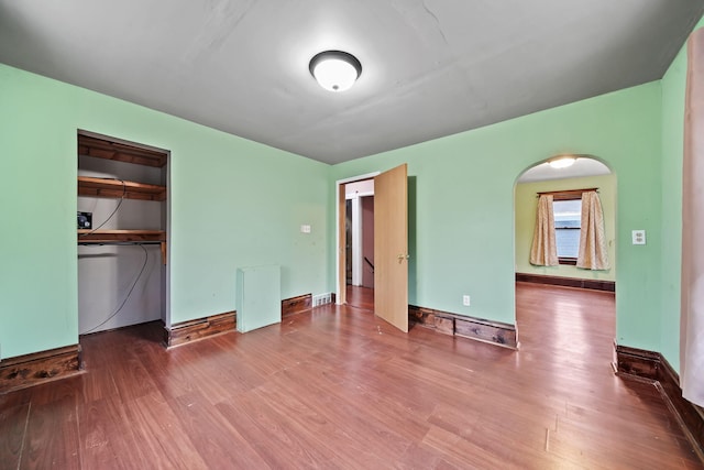 unfurnished bedroom with wood-type flooring and a closet