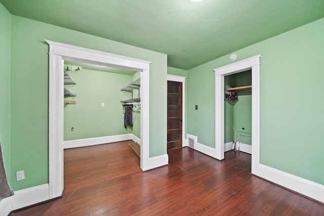 unfurnished bedroom with dark hardwood / wood-style floors