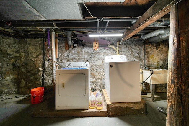 basement with separate washer and dryer and sink