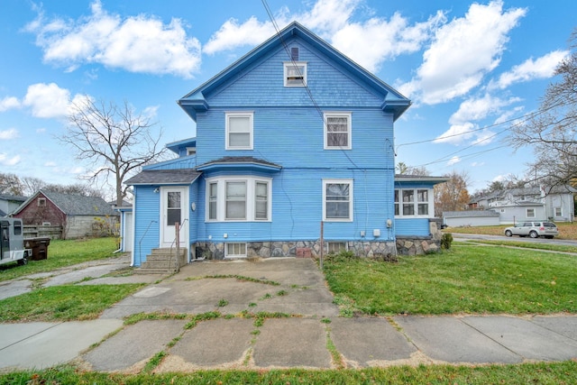 back of house with a lawn