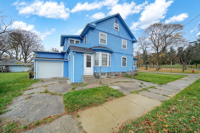 view of front of home with a garage and a front lawn