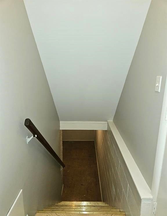 staircase featuring lofted ceiling