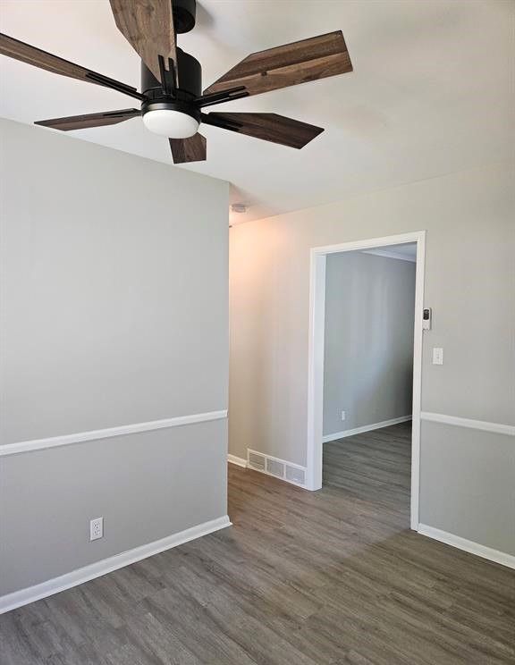 unfurnished room featuring ceiling fan and dark hardwood / wood-style floors