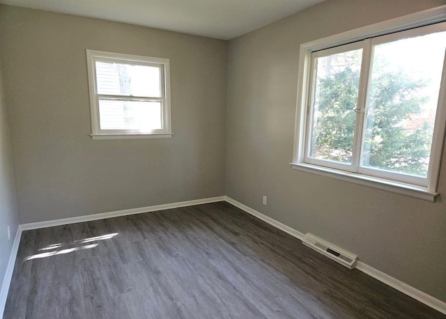 unfurnished room featuring dark hardwood / wood-style flooring