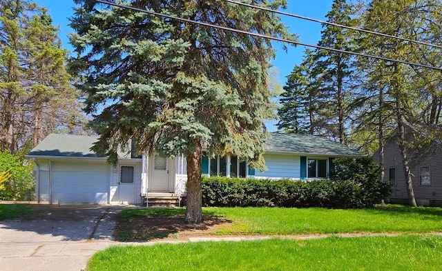 obstructed view of property featuring a garage and a front lawn