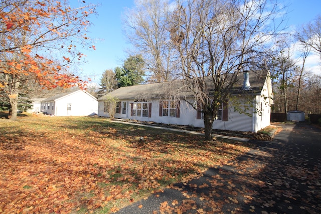 exterior space featuring a lawn and a shed