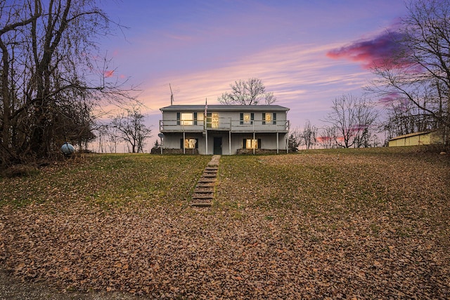 view of front property featuring a lawn and a deck