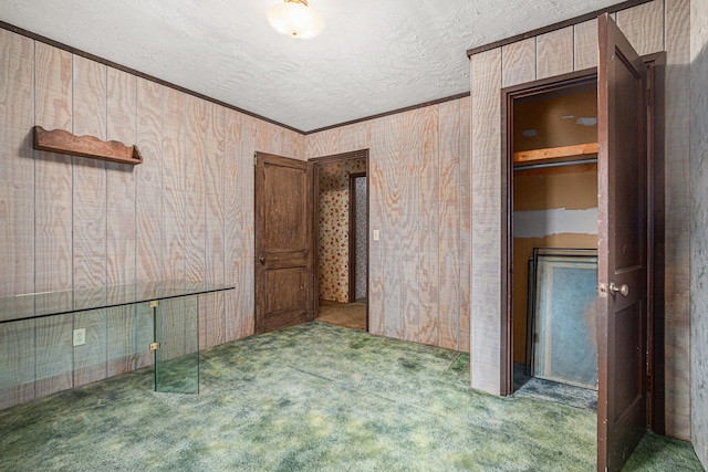 empty room with dark carpet and a textured ceiling