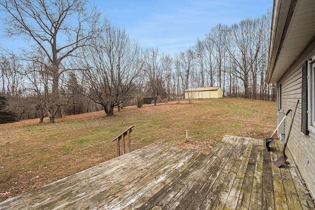 wooden deck with an outbuilding and a yard