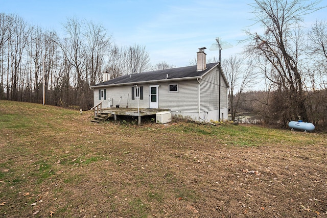 back of house with a lawn and a wooden deck