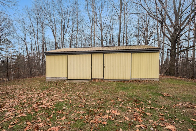 view of outdoor structure with a lawn