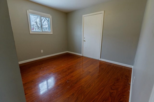 spare room featuring wood-type flooring