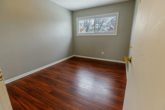 empty room with dark wood-type flooring