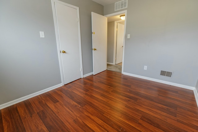 unfurnished bedroom featuring dark wood-type flooring