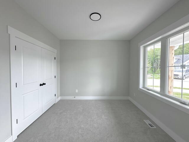 5184 Blendon Meadow Cir Unit 47, Hudsonville, MI 49426 - unfurnished bedroom featuring carpet, multiple windows, and baseboards