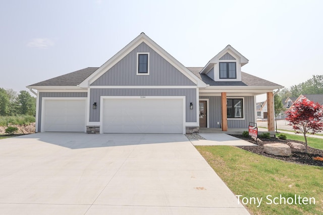 5184 Blendon Meadow Cir Unit 47, Hudsonville, MI 49426 - view of front of property featuring concrete driveway, covered porch, a garage, a shingled roof, and board and batten siding