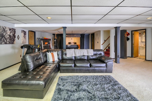 carpeted living room with a drop ceiling