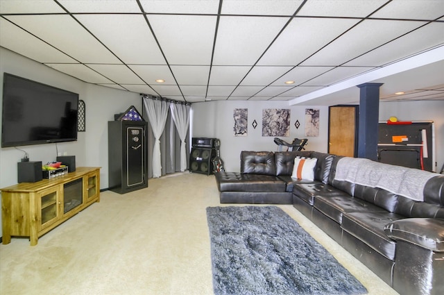 living room featuring carpet and a paneled ceiling