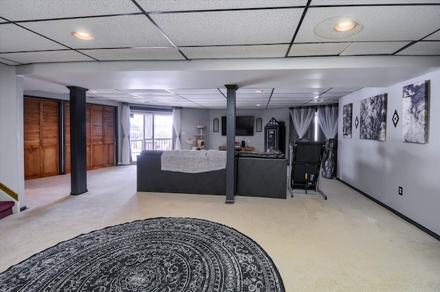 living room featuring carpet floors and a paneled ceiling