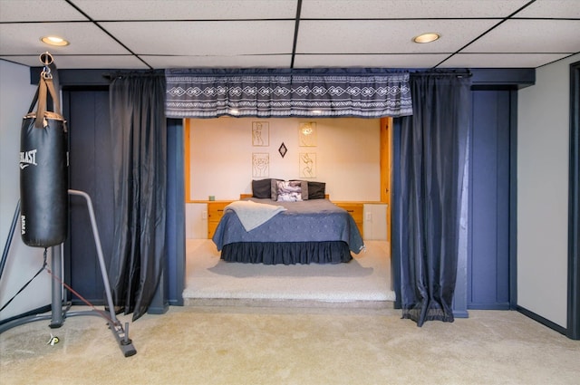 bedroom with carpet flooring and a paneled ceiling