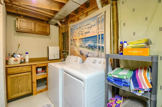 clothes washing area with washer and dryer