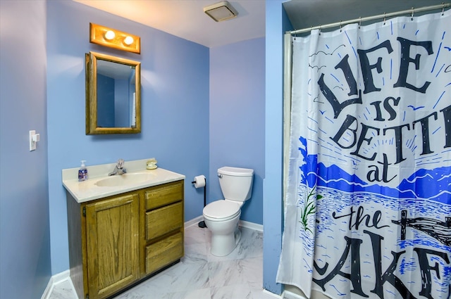 bathroom with vanity, toilet, and walk in shower