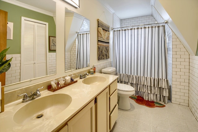 bathroom featuring vanity, crown molding, and tile walls