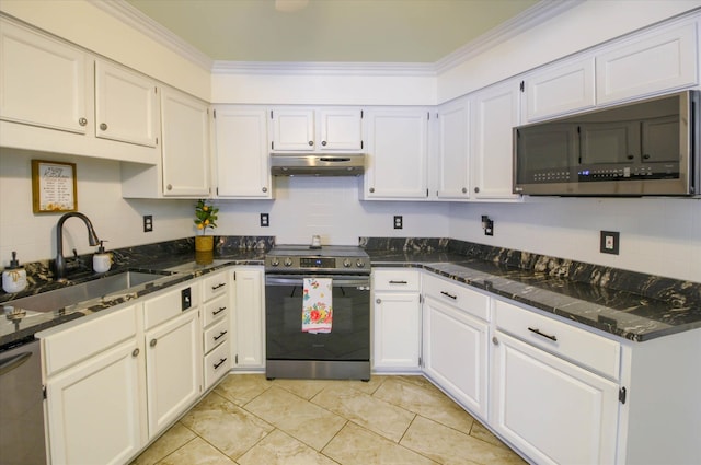 kitchen with dark stone counters, white cabinets, sink, ornamental molding, and stainless steel appliances