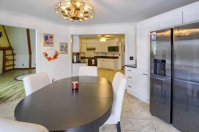 dining space with ceiling fan with notable chandelier and crown molding