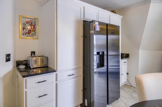 kitchen with white cabinetry, dark stone countertops, and stainless steel fridge with ice dispenser