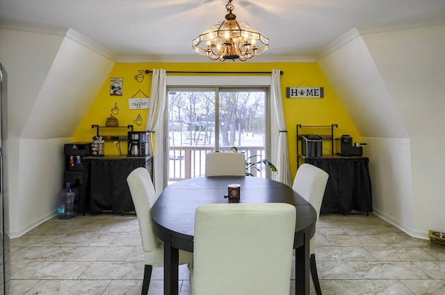 dining area with crown molding, lofted ceiling, and a notable chandelier