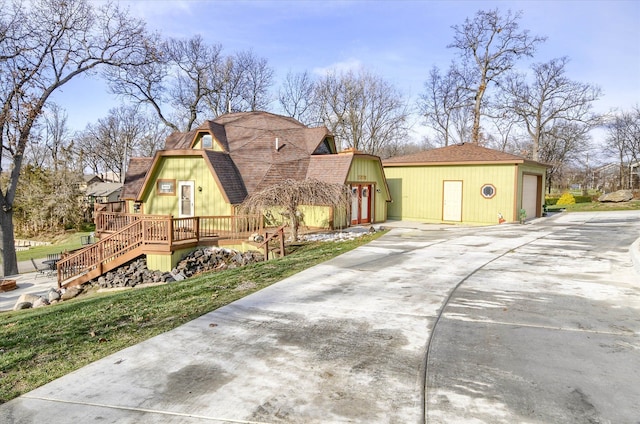 view of front of home featuring an outbuilding and a deck