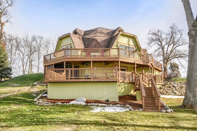 back of property with a wooden deck and a lawn