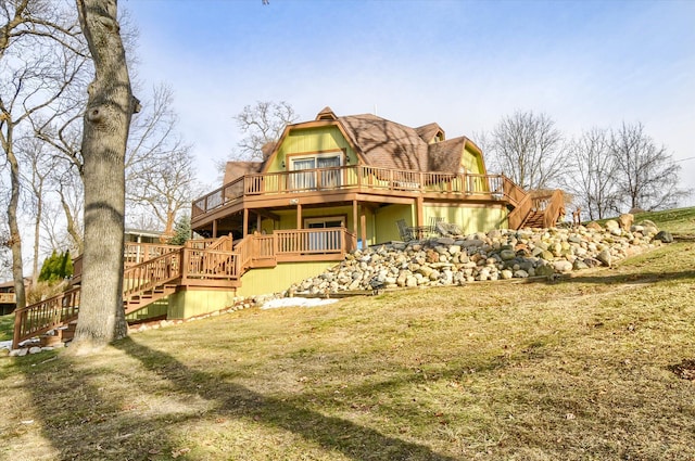 back of house featuring a lawn and a deck