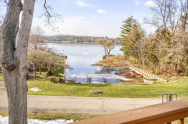 dock area featuring a yard and a water view